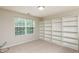 Bright bedroom features built-in shelving and a large window, creating a cozy and organized space at 3445 Dutchman Rd, Raleigh, NC 27610