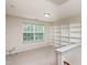 Bedroom features built-in shelves, a large window, and neutral carpet, creating an organized space at 3445 Dutchman Rd, Raleigh, NC 27610