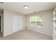 Bedroom with carpet, a window providing ample natural light, and double doors for easy closet access at 3445 Dutchman Rd, Raleigh, NC 27610