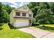 Charming two-story home with a two-car garage, red shutters, and a well-manicured lawn at 3445 Dutchman Rd, Raleigh, NC 27610