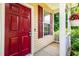 Close-up of the home's welcoming front porch with a red door and white trim at 3445 Dutchman Rd, Raleigh, NC 27610