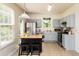 Spacious kitchen with blue cabinets, stainless steel appliances, and a black island with seating at 3445 Dutchman Rd, Raleigh, NC 27610