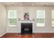 Bright living room with a fireplace and large windows at 3445 Dutchman Rd, Raleigh, NC 27610