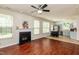 Open living room with a fireplace, ceiling fan, and views into the kitchen at 3445 Dutchman Rd, Raleigh, NC 27610