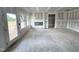 Large living room featuring a fireplace, a door to the backyard, and plenty of natural light at 360 Ambassador Dr, Clayton, NC 27520
