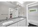 Bathroom with double sink vanity, granite countertops, and a tub with white tiled walls at 3604 Thorndike Dr, Wake Forest, NC 27587