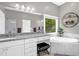 Elegant bathroom features a soaking tub with tile surround, granite countertops, and a large window at 3604 Thorndike Dr, Wake Forest, NC 27587