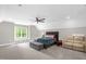 Spacious bedroom with ample seating, a ceiling fan and a large window at 3604 Thorndike Dr, Wake Forest, NC 27587