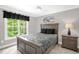 Bedroom with a queen-size bed, nightstand, and large window offering ample natural light at 3604 Thorndike Dr, Wake Forest, NC 27587
