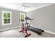 Bedroom features a ceiling fan and two large windows with a treadmill and stationary bike at 3604 Thorndike Dr, Wake Forest, NC 27587