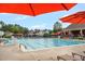 Spacious community pool with ample seating, umbrellas, and a slide, ideal for summer relaxation and recreation at 3604 Thorndike Dr, Wake Forest, NC 27587