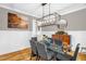 Stylish dining room featuring a modern chandelier, a glass table, and wainscoting at 3604 Thorndike Dr, Wake Forest, NC 27587