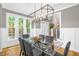 Bright dining room with large windows, modern chandelier and hardwood floors at 3604 Thorndike Dr, Wake Forest, NC 27587