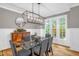 Dining room showcasing a glass table, modern lighting fixture and natural light at 3604 Thorndike Dr, Wake Forest, NC 27587