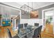 Charming dining room featuring a modern chandelier, hardwood floors, and access to the staircase at 3604 Thorndike Dr, Wake Forest, NC 27587