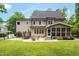 Spacious backyard with patio, a grilling area, and a manicured lawn extending to the home's back facade at 3604 Thorndike Dr, Wake Forest, NC 27587