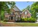 Charming brick home featuring meticulously maintained landscaping and architectural details at 3604 Thorndike Dr, Wake Forest, NC 27587