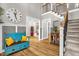 Open foyer with a staircase, hardwood floors and a bench with decorative pillows at 3604 Thorndike Dr, Wake Forest, NC 27587