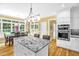Bright open kitchen with island, granite countertops, and stainless steel appliances next to the dining area at 3604 Thorndike Dr, Wake Forest, NC 27587
