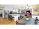 Open concept view from kitchen to the living room with yellow accents and modern lighting at 3604 Thorndike Dr, Wake Forest, NC 27587