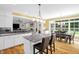 Elegant kitchen with island, granite countertops, stainless appliances, open to living and dining areas at 3604 Thorndike Dr, Wake Forest, NC 27587