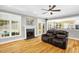 Inviting living room with fireplace, ceiling fan, and view to the kitchen and backyard at 3604 Thorndike Dr, Wake Forest, NC 27587