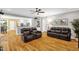 Open-concept living room with view into kitchen, featuring hardwood floors and comfortable seating at 3604 Thorndike Dr, Wake Forest, NC 27587