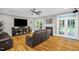 Comfortable living room featuring a fireplace, large TV, and access to the patio at 3604 Thorndike Dr, Wake Forest, NC 27587