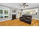 Cozy living room with fireplace, ceiling fan, and view to the kitchen and backyard at 3604 Thorndike Dr, Wake Forest, NC 27587