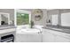 Bright bathroom featuring a soaking tub with marble surround, granite counters, and backyard view at 3604 Thorndike Dr, Wake Forest, NC 27587
