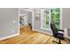 Bright office space with hardwood floors, large windows, and view to staircase at 3604 Thorndike Dr, Wake Forest, NC 27587