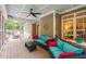 Inviting screened-in porch with cozy seating, ceiling fan, and views of the serene outdoor space at 3604 Thorndike Dr, Wake Forest, NC 27587