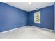 Bedroom with blue walls and natural light from window at 3605 Iron Sight Ct, Raleigh, NC 27616