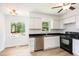 Bright kitchen with stainless steel dishwasher and black countertops, offering serene outdoor views at 3605 Iron Sight Ct, Raleigh, NC 27616