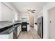 Modern kitchen featuring white cabinets, stainless steel appliances, and dark countertops at 3605 Iron Sight Ct, Raleigh, NC 27616