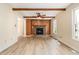 Spacious living room featuring wood beams, fireplace, and light-colored flooring for a cozy atmosphere at 3605 Iron Sight Ct, Raleigh, NC 27616