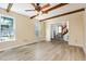 Bright living room with wood-look floors, large windows, and views into the entry and front yard at 3605 Iron Sight Ct, Raleigh, NC 27616