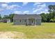 Charming gray home with a covered front porch and classic architectural details, set on a green lawn at 3724 Stevens Chapel Rd, Smithfield, NC 27577