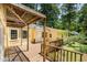 Backyard deck with wood railing and pergola overlooking a private, wooded yard at 420 Lipscomb Grove Church Rd, Hillsborough, NC 27278
