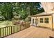 Expansive wooden deck with a pergola providing shade, overlooking the wooded backyard at 420 Lipscomb Grove Church Rd, Hillsborough, NC 27278