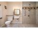 Accessible bathroom featuring a shower, grab bars, sink, and neutral tile at 420 Lipscomb Grove Church Rd, Hillsborough, NC 27278