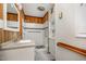 Bathroom with wood paneling, granite countertop and shower with white tile and mosaic accents at 420 Lipscomb Grove Church Rd, Hillsborough, NC 27278