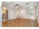 Bright bedroom featuring hardwood flooring, large windows, a ceiling fan, and access to an accessible bathroom at 420 Lipscomb Grove Church Rd, Hillsborough, NC 27278