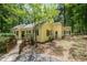 Inviting yellow home featuring a walkway and black shutters, nestled amongst lush greenery at 420 Lipscomb Grove Church Rd, Hillsborough, NC 27278
