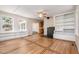 Bright living room featuring hardwood floors, built-in shelving, and a charming fireplace at 420 Lipscomb Grove Church Rd, Hillsborough, NC 27278