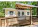 Charming shed with ramp access, double doors, and windows surrounded by lush greenery at 420 Lipscomb Grove Church Rd, Hillsborough, NC 27278