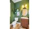 Stylish half bath features a wood vanity, modern fixtures, and tasteful decor at 426 Granite Mill Blvd, Chapel Hill, NC 27516