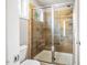 Contemporary bathroom showcasing a frameless glass shower with wood-look tile, built-in bench, and a convenient window at 426 Granite Mill Blvd, Chapel Hill, NC 27516