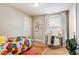 Inviting bedroom with a cozy desk area, floral-themed bedspread, and ample natural light at 426 Granite Mill Blvd, Chapel Hill, NC 27516