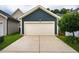 Detached two car garage with concrete driveway and well maintained yard located behind the home at 426 Granite Mill Blvd, Chapel Hill, NC 27516